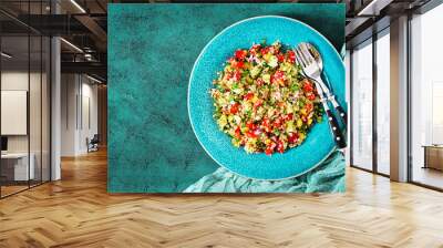 Salad with quinoa, arugula, sweet peppers, tomatoes and cucumber in bowl on a dark background. Healthy food, diet, detox and vegetarian concept. Tabbouleh salad. Top view. Flat lay Wall mural