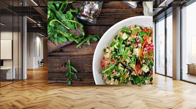 Salads with quinoa,  arugula, radish, tomatoes and cucumber in bowl on  wooden background.  Healthy food, diet, detox and vegetarian concept. Top view. Flat lay Wall mural