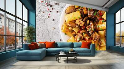 Vegetarian pasta  rigatoni with mushrooms and chilli peppers in white bowl on grey table. Vegan food. Flat lay. Banner. Top view Wall mural