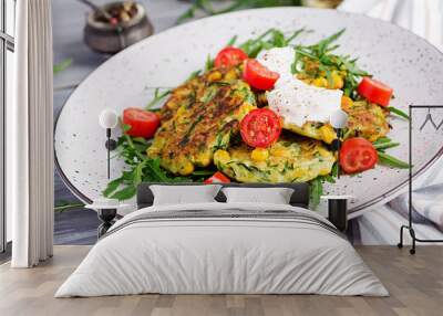 Zucchini pancakes with corn and sour cream served arugula, tomatoes salad. Wall mural