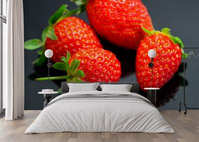 Macro image of fresh red strawberries group isolated at black background with reflection. Wall mural