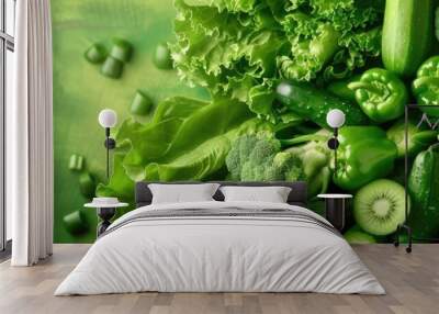 A vibrant assortment of fresh green vegetables including broccoli, lettuce, kiwi, and green peppers, ideal for healthy eating and nutrition concepts. Wall mural