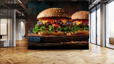 Delicious grilled burgers with fresh vegetables on a wooden board, surrounded by flames, capturing the essence of barbecue perfection. Wall mural