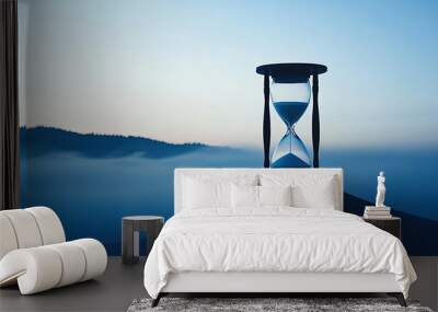 Hourglass atop a hill, symbolizing time in a serene twilight setting. Wall mural