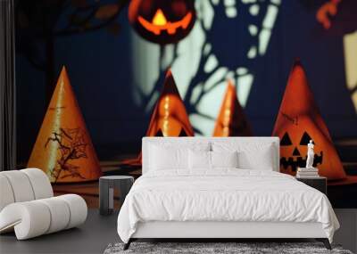 Spooky Halloween decorations featuring orange party hats with jack-o'-lantern designs and eerie shadows. Wall mural