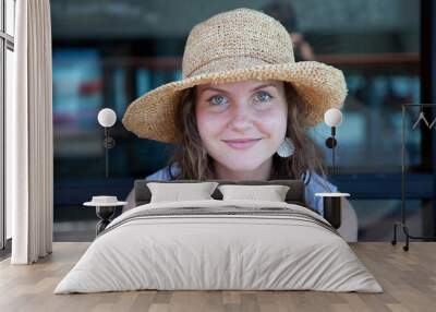 portrait of a young smiling happy woman in a straw hat on a vacation Wall mural