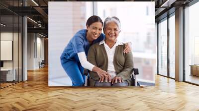 Portrait, smile and nurse with a senior woman in a wheelchair, care and rehabilitation. Face, happy female person and eldery lady with a medical professional, recovery and person with a disability Wall mural