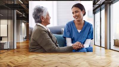 Im here to lend my support whenever you need. Shot of a young nurse chatting to a senior woman in a retirement home. Wall mural