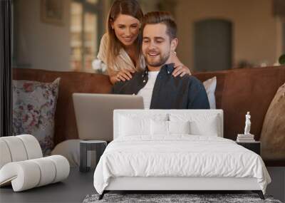 Relax, laptop and web with a couple on the living room sofa of their home together. Computer, social media or internet with a man and woman online to search while relaxing and bonding in a house Wall mural