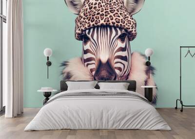 Close-up portrait of cute zebra wearing leopard fur cap on pastel green background Wall mural