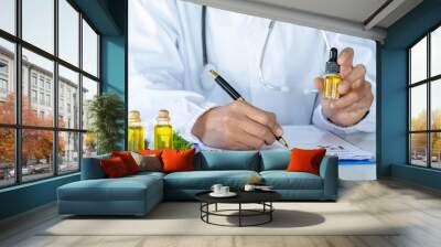  Doctor holding a bottle of hemp oil and offer to patient medical marijuana and oil.  alternative remedy or medication,medicine concept. Wall mural