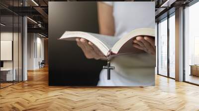  woman praying on holy bible in the morning. woman hand with Bible praying. Wall mural