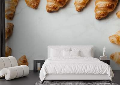 A circular arrangement of golden, flaky croissants on a light marble surface, creating a visually appealing and inviting scene. Wall mural