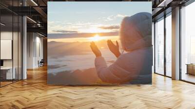 Christian woman  hands praying to god on the mountain background with morning sunrise. Woman Pray for god blessing to wishing have a better life. Christian life crisis prayer to god. Wall mural