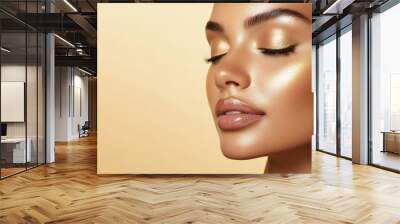 Close-up portrait of a woman with glowing skin and closed eyes. Her face is smooth and radiant, with a hint of golden shimmer. Wall mural