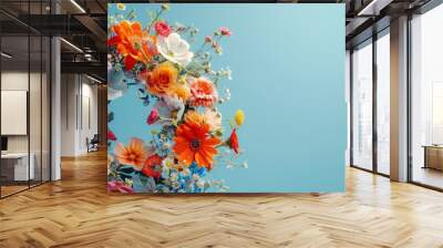 Colorful flower wreath with a mix of vibrant flowers against a bright blue background. Ideal for spring and summer themes. Wall mural