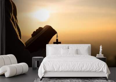 Hands of a Christian man holding a bible while praying to God, Religious beliefs, Copy space. Wall mural