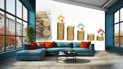 Mini house on stack of coins, isolated on white background, Concept of Investment property. Wall mural