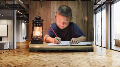 Poor children write books illuminating with oil lamps, Disadvantaged Children doing homework, Education Concept. Wall mural