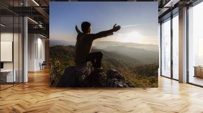 silhouette of a man praying to god on the mountain Pray with hands with faith in religion and belief in God on blessing basis. the power of hope or love and devotion. Wall mural