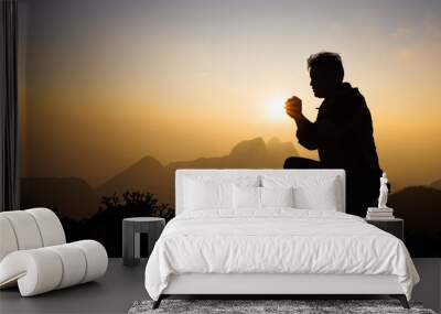 Silhouette of christian man hand praying,spirituality and religion,man praying to god. Christianity concept.   Freedom and travel adventure. Wall mural