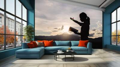 Silhouette of Religious young woman praying to God in the morning, spirtuality and religion,  Christians and Bible study concept. Wall mural