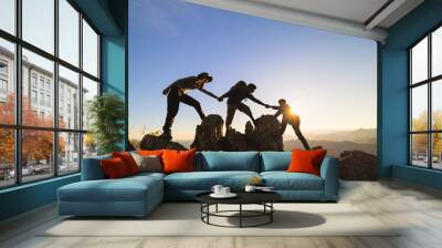 silhouette of Teamwork of two men hiker helping each other on top of mountain climbing team. Teamwork friendship hiking help each other trust assistance silhouette in mountains, sunrise. Wall mural