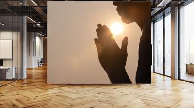 Silhouette of woman prayer position, Praying hands with faith in religion and belief in God on dark background. Power of hope or love and devotion. Namaste or Namaskar hands gesture. Wall mural