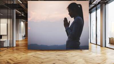 woman praying prayers for spiritual faith A prayer to remember God. Faith in religion and belief in God based on blessings. God's help. Wall mural