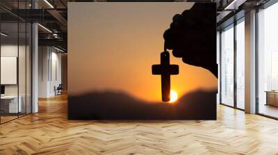 Young man praying With the  Holy Cross in the morning Wall mural