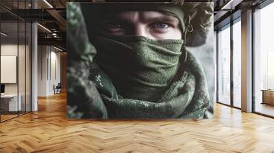 A closeup of a soldier in military camouflage uniform, wearing a helmet and a scarf covering his face. The focus is on his eyebrow, eye, jaw, and armyissued gear Wall mural