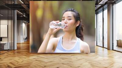 Young Asian woman and a bottle of water Wall mural