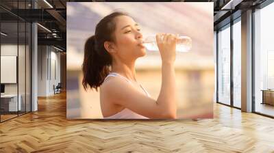 Young Asian woman drink water Wall mural