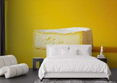 Creamy cheese on bright yellow background, showcasing its texture and color Wall mural