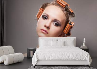 Stylish girl portrait with fashion makeup and hair curlers, isol Wall mural