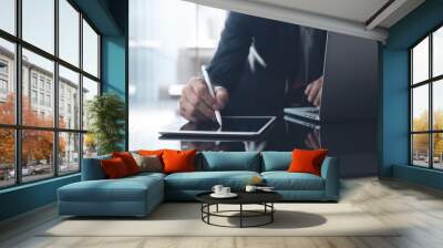 Asian businessman manager working on digital tablet and laptop computer in modern office Wall mural