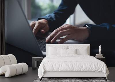 Business man hands typing on laptop computer keyboard, searching information, surfing the internet on dark office desk, distance job, online working, business and technology concept Wall mural