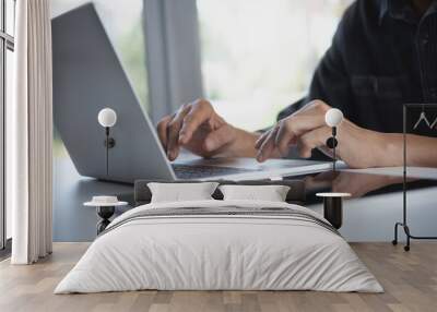 Businessman working laptop computer, surfing the internet with digital tablet on the table at home office. Working at home, telecommuting concept Wall mural