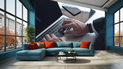 Businessman working on laptop computer on white table at office. Business man hands typing on laptop, online working, surfing the internet, close up Wall mural