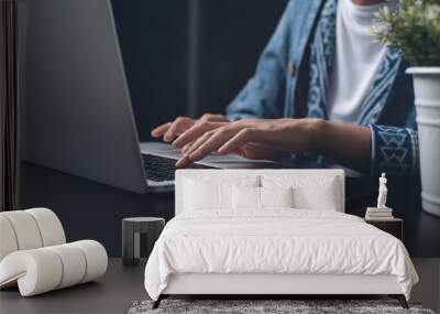 Casual woman hand typing on laptop computer overtime working at night at home office Wall mural