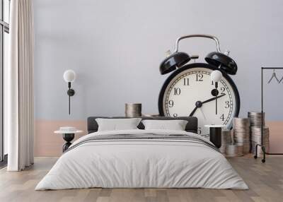 Clock and coin tower on table Wall mural