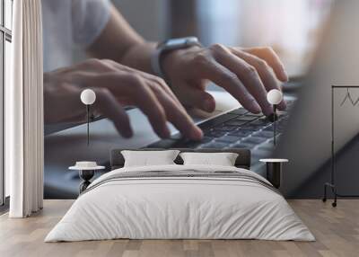 Close up of woman hands typing on laptop computer keyboard on table with sunlight Wall mural