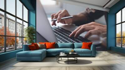 Man working on laptop computer Wall mural