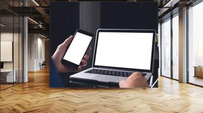 Mockup of man using mobile smart phone and laptop computer Wall mural