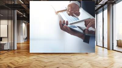 Two businessmen sitting at table, using digital tablet and laptop co-working at modern office, close up. Business colleagues working together, having a discussion on a project Wall mural