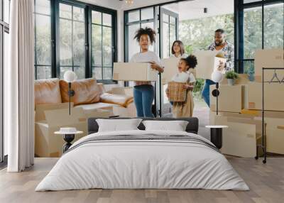 Happy African American young family bought new house. Mom, Dad, and child smiling happy hold cardboard boxes for move object walking into big modern home. New real estate dwelling, loan and mortgage. Wall mural