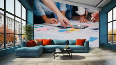 Millennial Asia businessmen and businesswomen meeting brainstorming ideas about new paperwork project colleagues working together planning success strategy enjoy teamwork in small modern night office. Wall mural