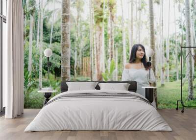 Young Asian woman relax in forest, Beautiful female happy using relax time in nature. Lifestyle women travel in forest concept. Wall mural