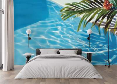 Bright palm leaves and vibrant tomatoes cast shadows over a rippling blue pool. Wall mural