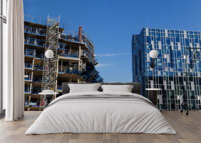 Building crane and construction site under blue sky. Wall mural